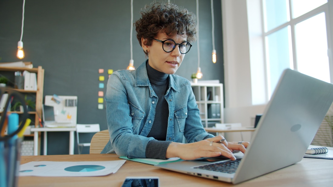 Administradora de agencia trabajando en el sistema desde su laptop